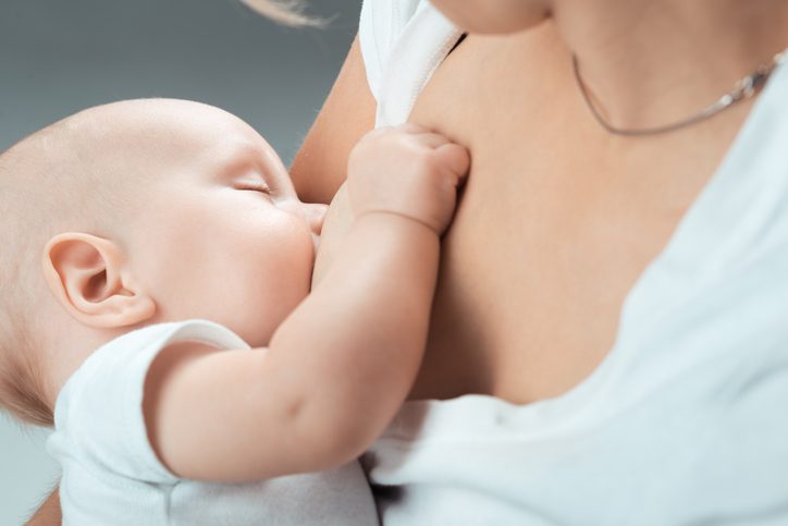 mother breastfeeding after breast implants in san diego